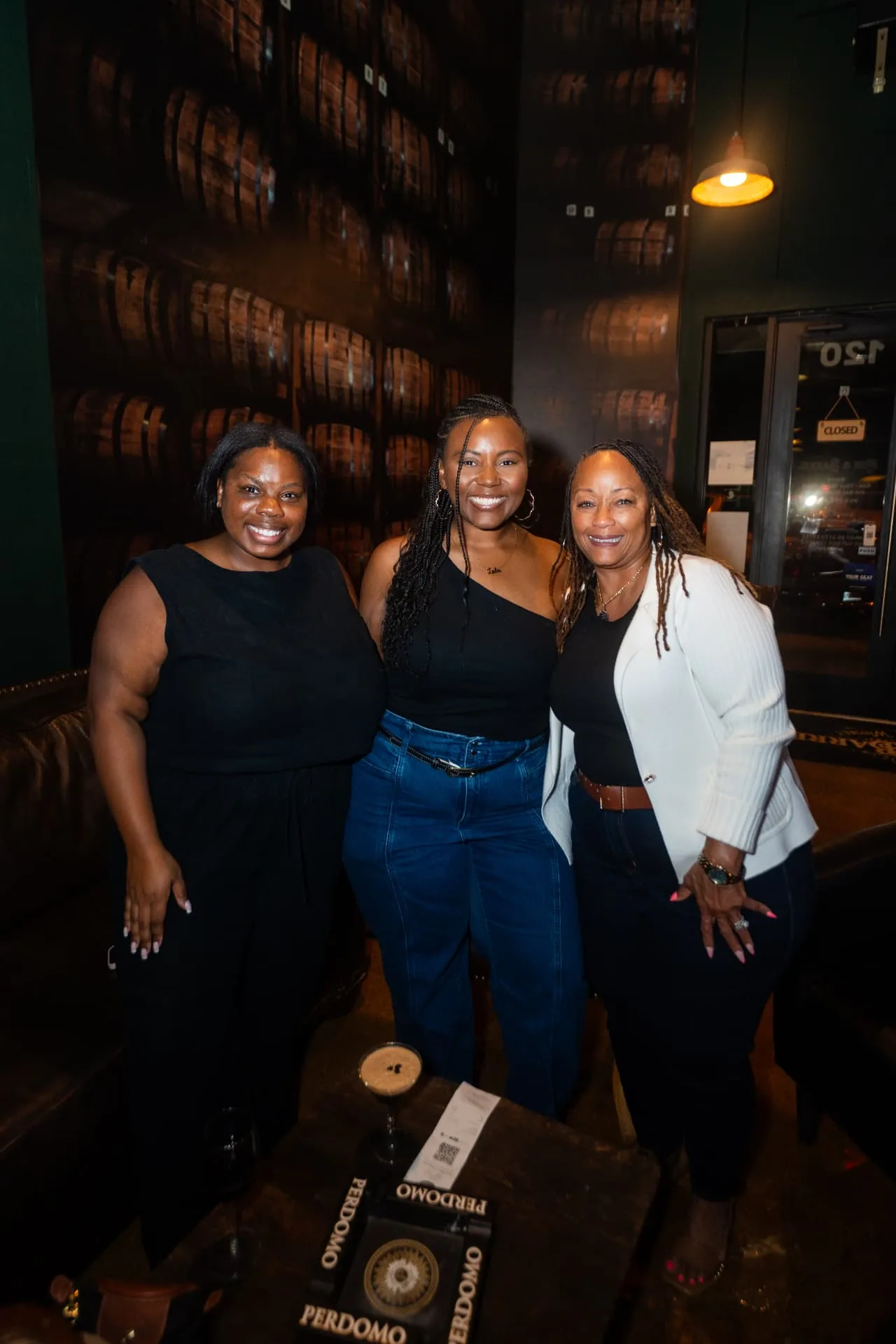 Friends enjoying a night at Ash & Barrel