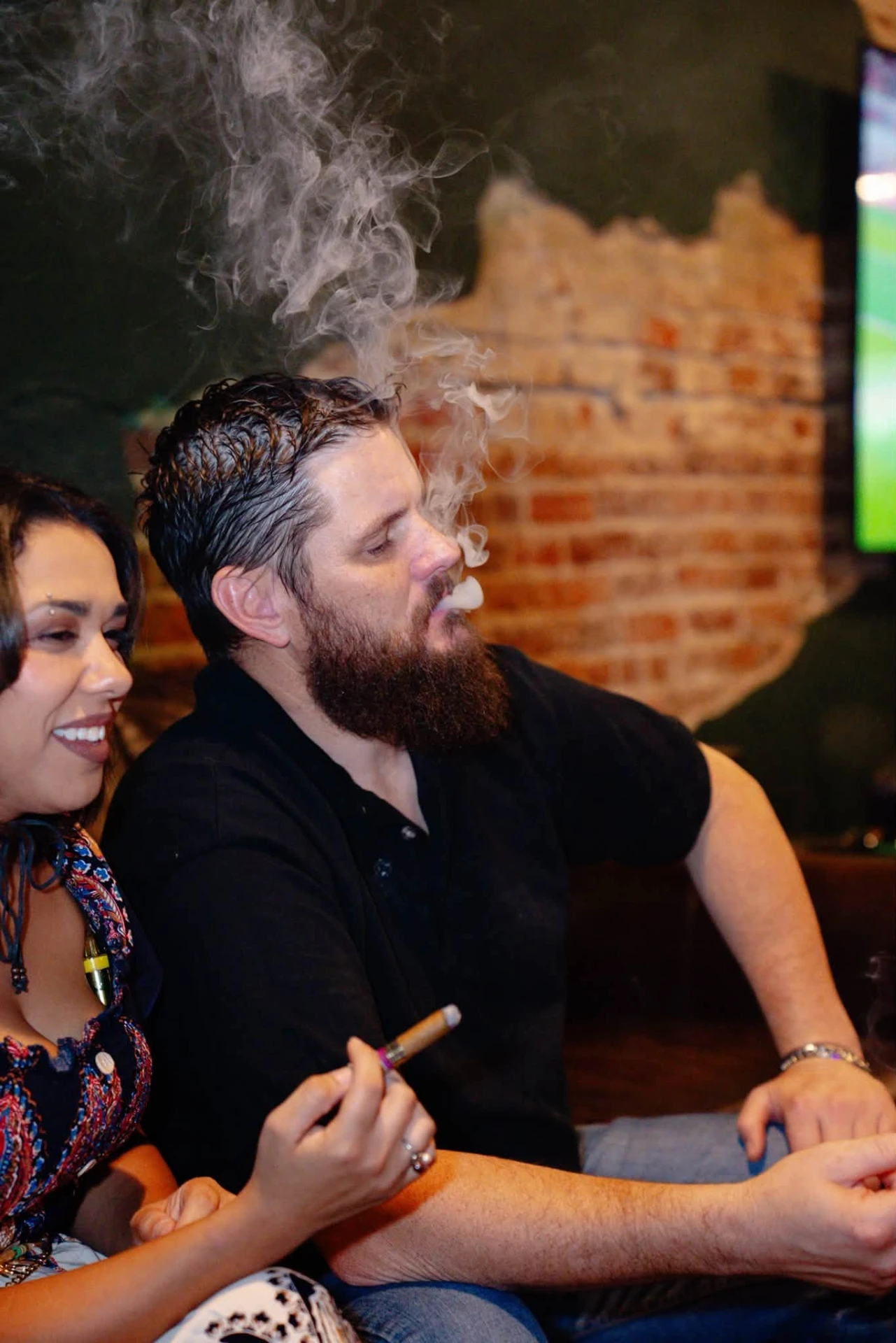 Guests by the brick wall at Ash & Barrel