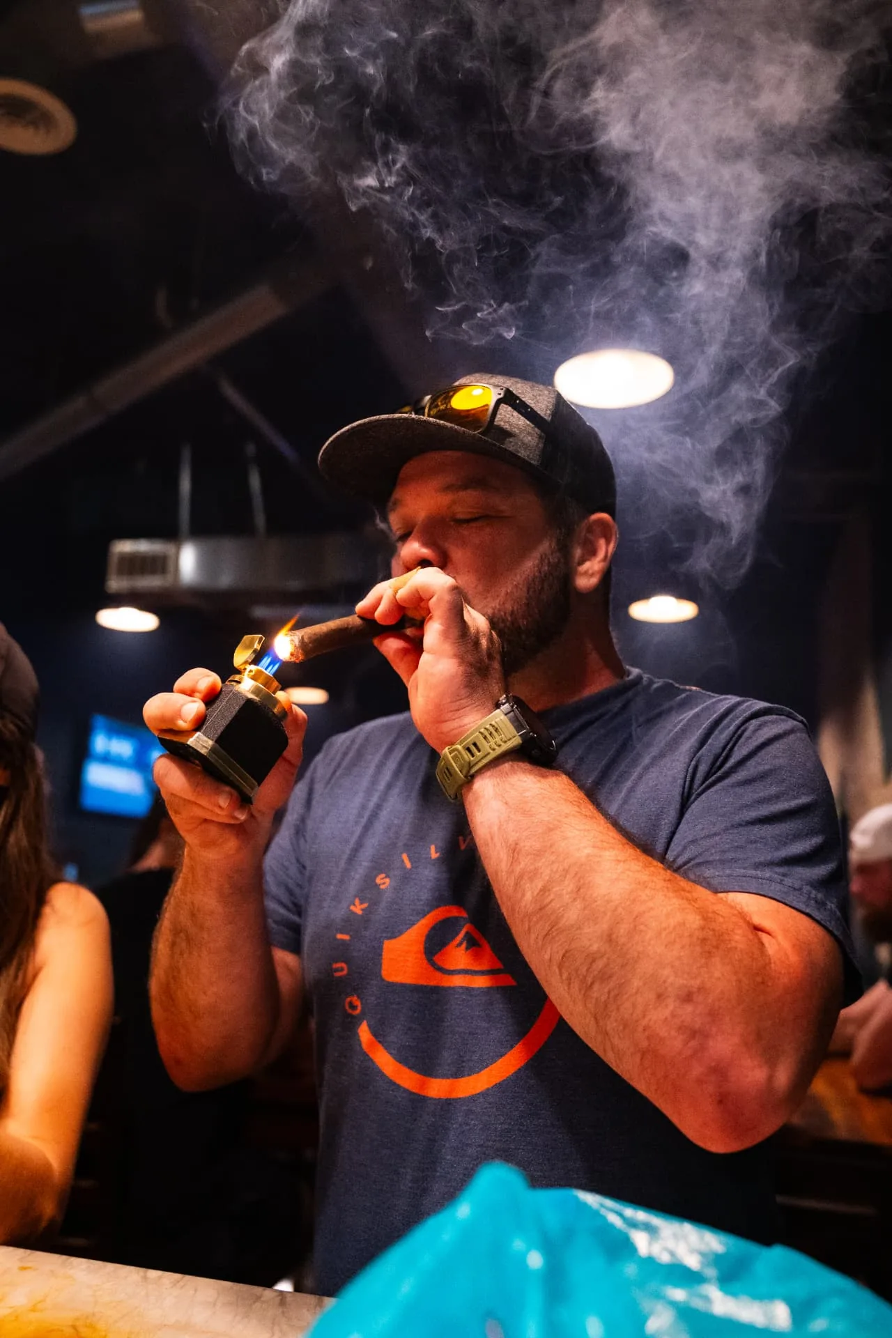 Guest lighting a cigar at the bar