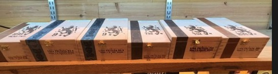 Liga Privada No. 9, T52, and H99 boxes in the Ash & Barrel humidor.