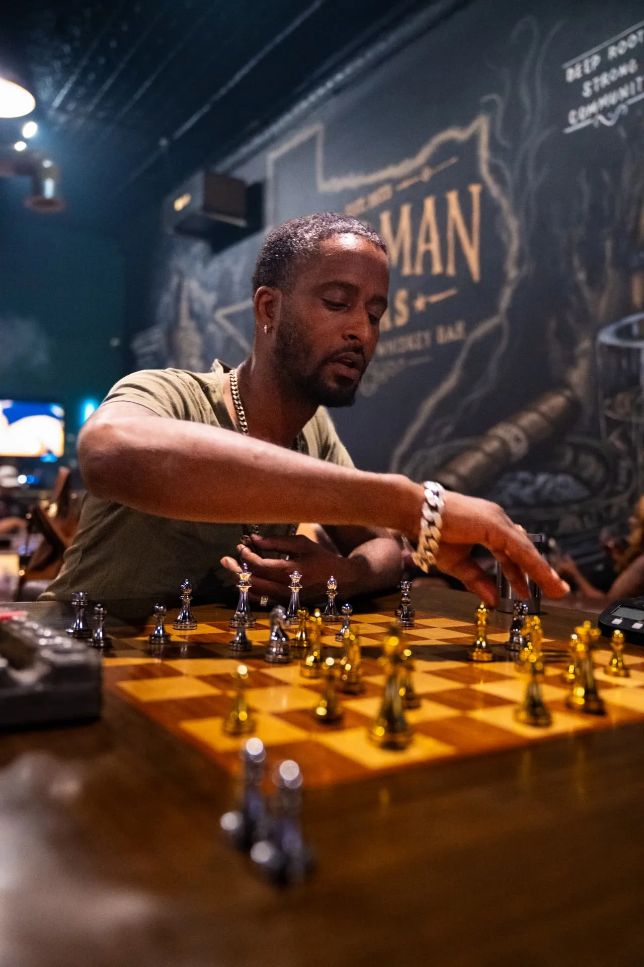 Guest playing chess at Ash & Barrel