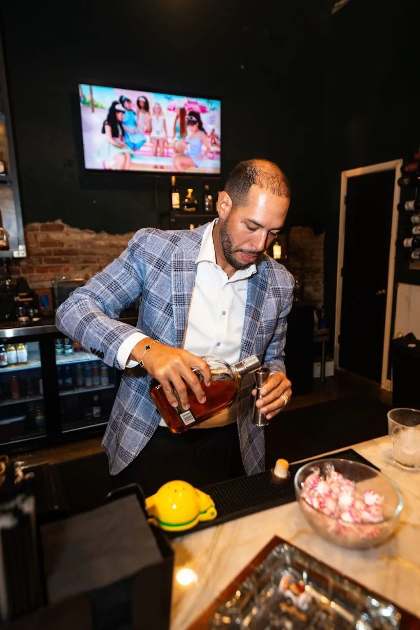 Pouring whiskey behind the bar