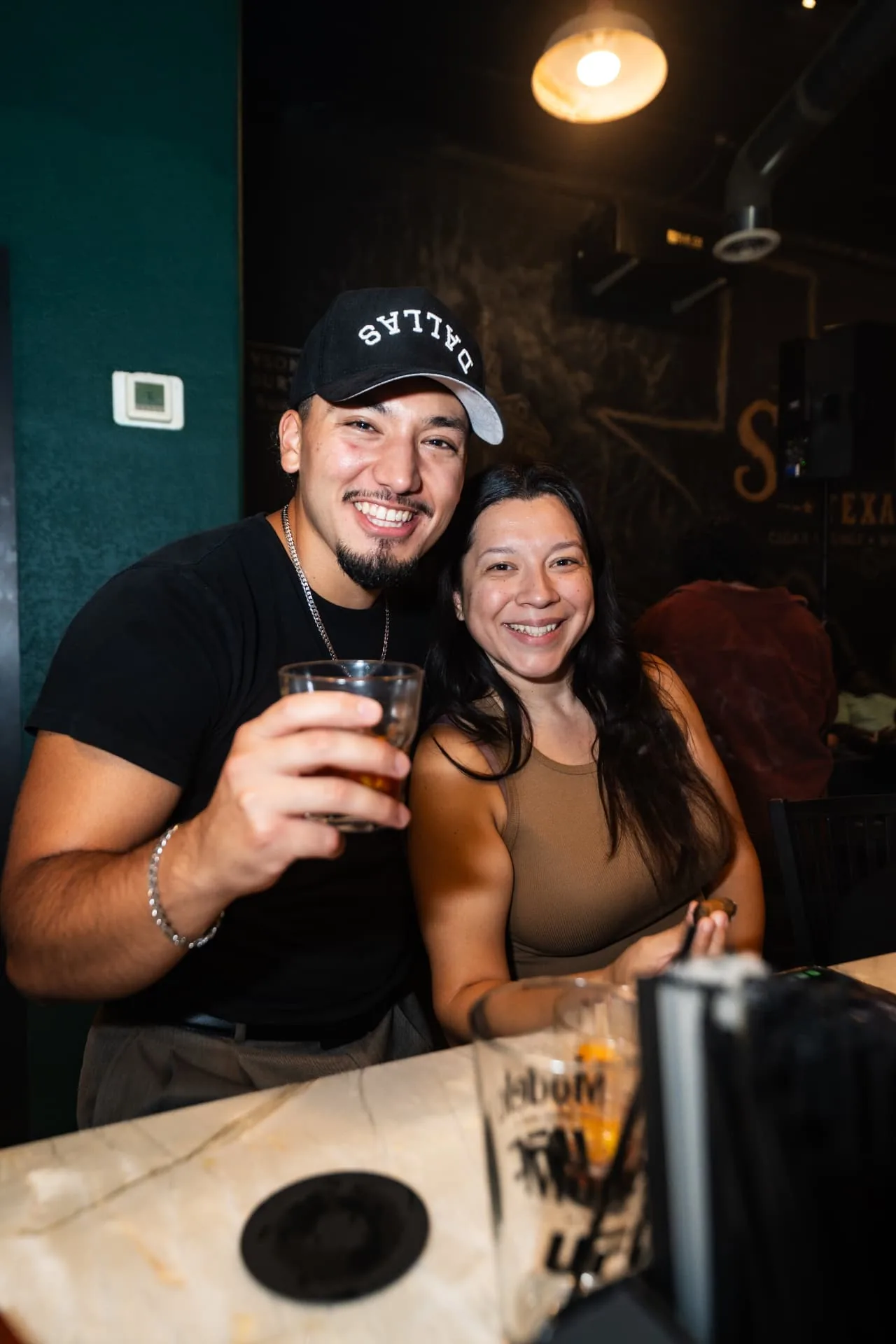 Guests sharing a drink at Ash & Barrel