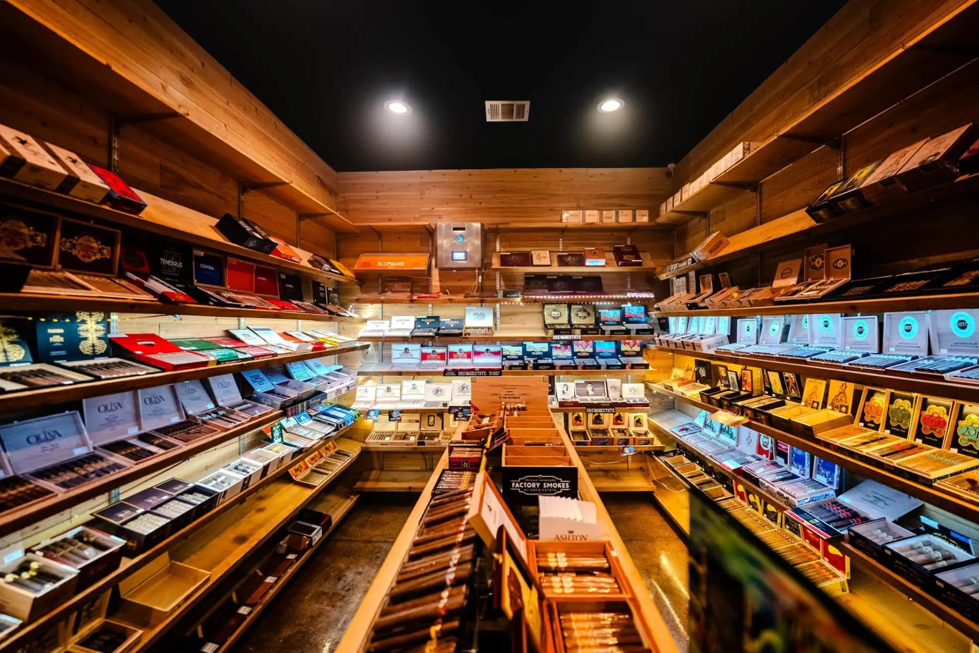 Shelves of premium cigars inside the Ash & Barrel walk-in humidor