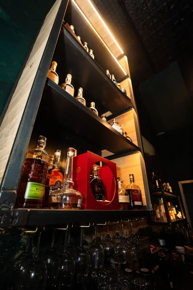 Illuminated liquor shelves at the bar