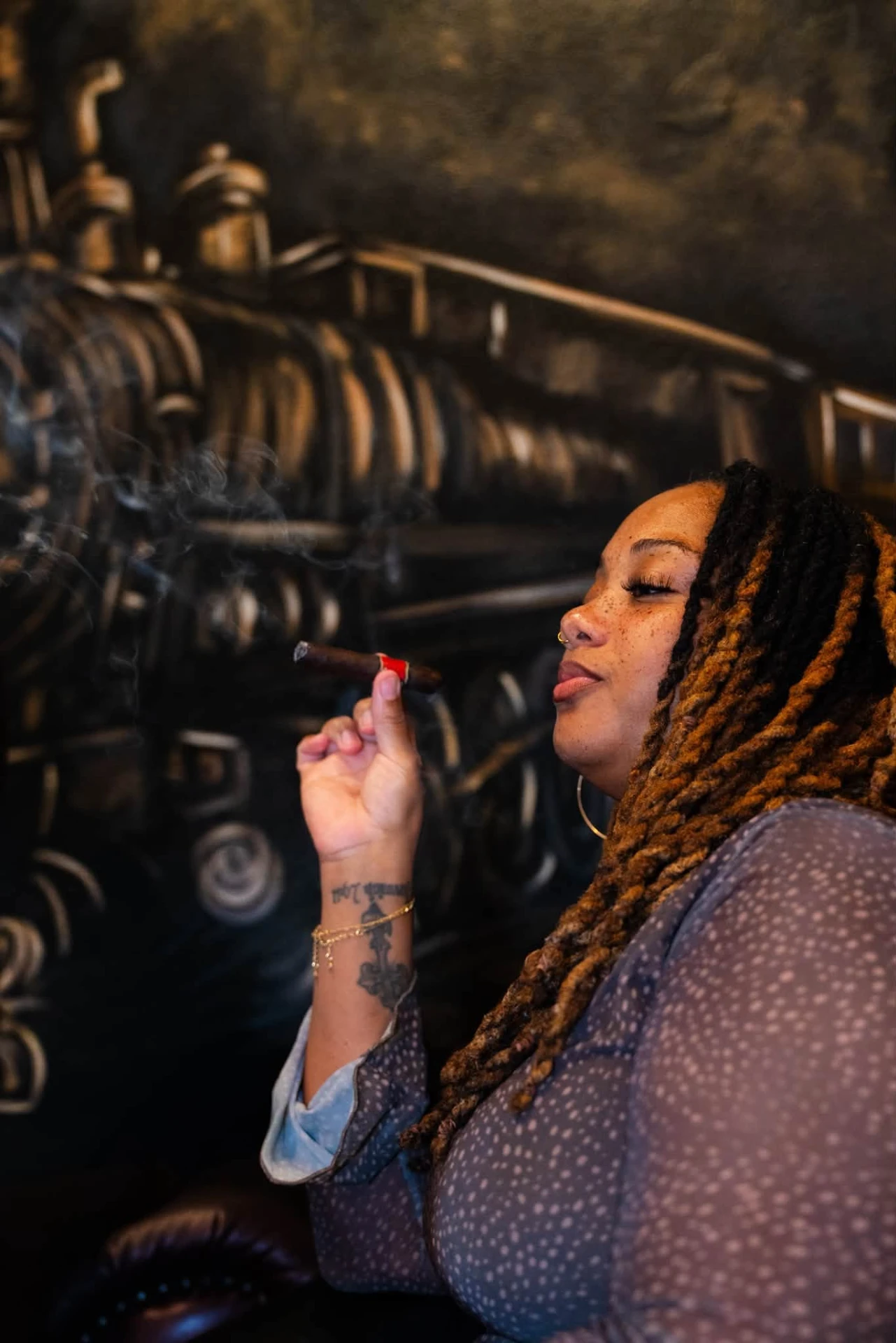 Guest with a cigar in front of the train mural