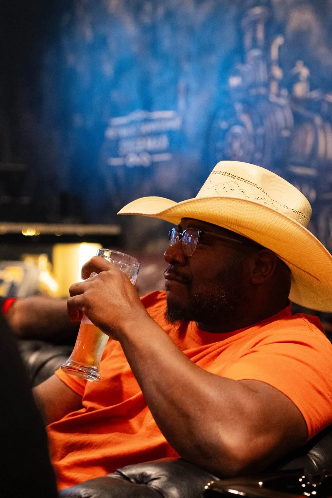 Guest in a cowboy hat enjoying a beer